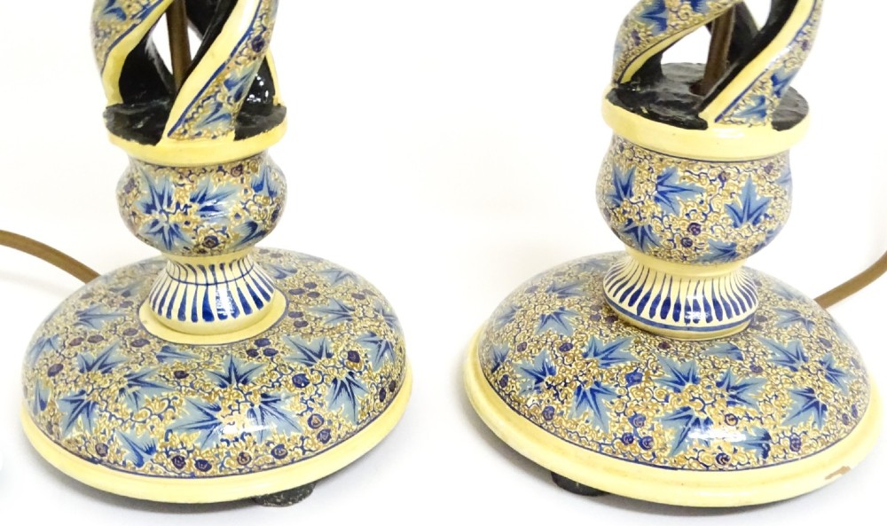 A pair of early 20th-century Kashmiri table lamps with open-spiral turned columns hand-painted in blue floral patterns on a cream lacquered ground. View IV