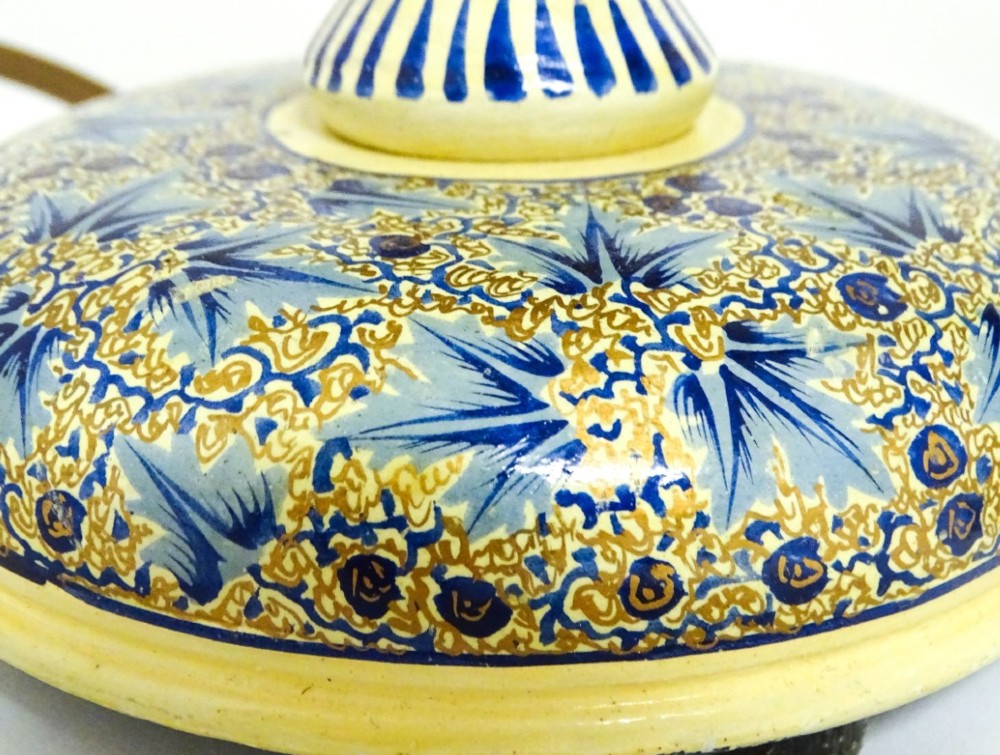 A pair of early 20th-century Kashmiri table lamps with open-spiral turned columns hand-painted in blue floral patterns on a cream lacquered ground. View V