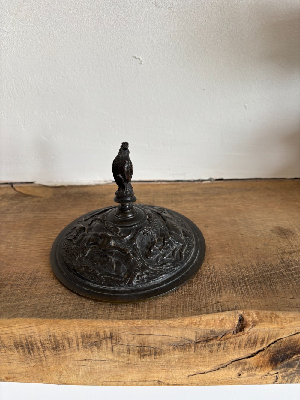 A pair of dark patinated bronze covered urns featuring relief-sculpted avian motifs and stork-shaped handles and finials on tiered bases. View IV