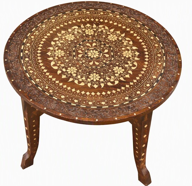 A circular dark brown wood occasional table with intricate concentric bone inlay motifs and carved cabriole legs.
