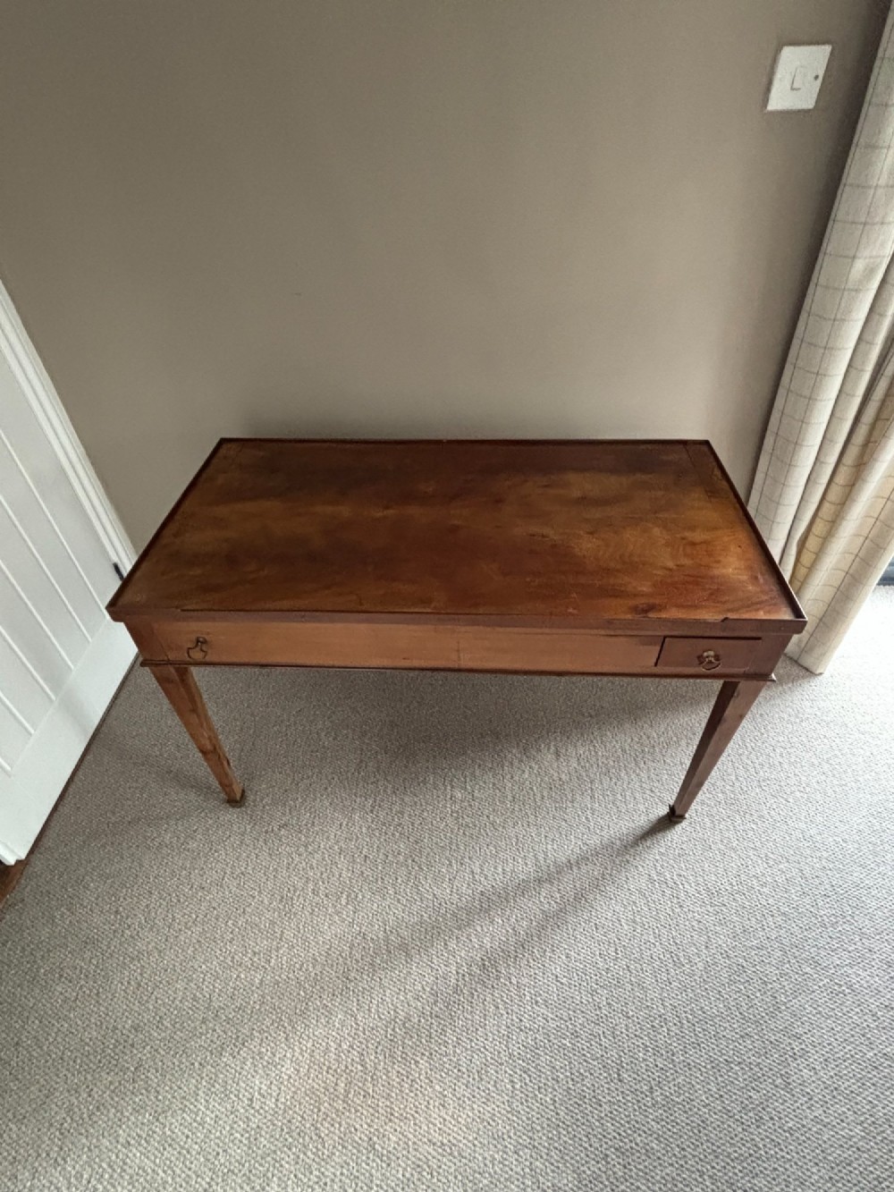 A French Empire mahogany tric-trac games table featuring a sunken central backgammon board with inlaid points and brass eyelets around the border. View VII