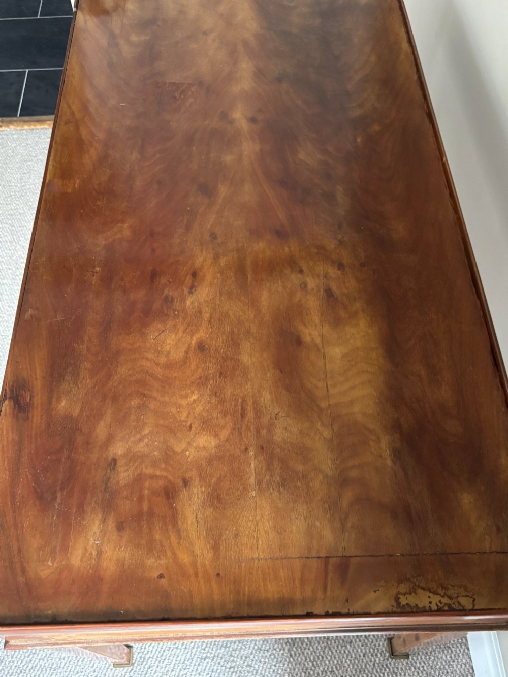 A French Empire mahogany tric-trac games table featuring a sunken central backgammon board with inlaid points and brass eyelets around the border. View VIII