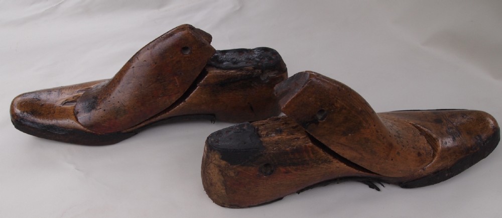 A pair of late 19th-century carved beechwood gents shoe lasts with a warm brown patinated finish and visible cobbler pin marks. View IV