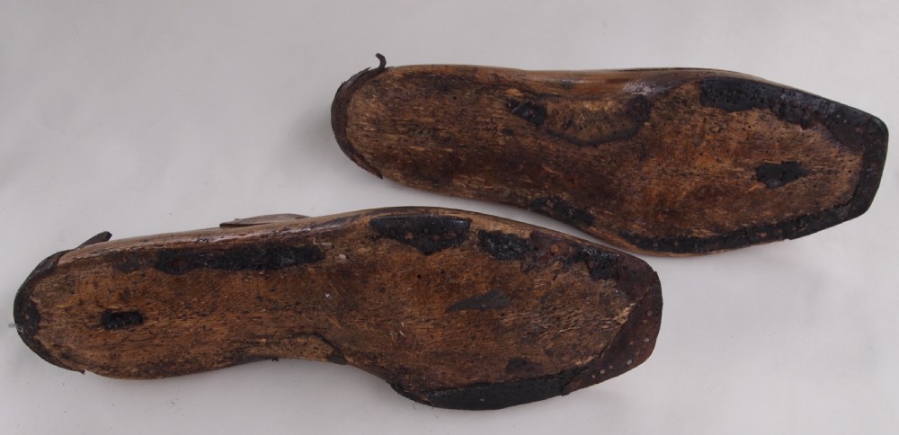 A pair of late 19th-century carved beechwood ladies shoe lasts featuring a warm brown patina and leather pull tabs. View III