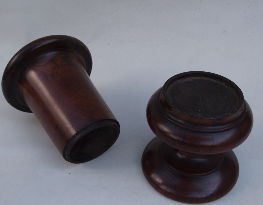 A turned yew wood spill vase featuring a flared rim, waist moulding, and a circular turned pedestal base in a rich warm brown finish. View V