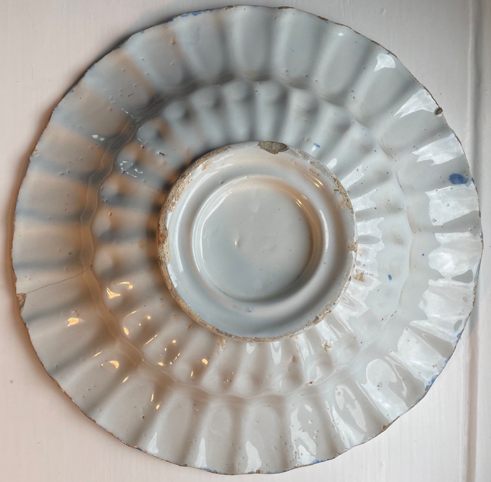 An eighteenth-century Dutch Delftware tin-glazed earthenware shallow bowl with cobalt blue hand-painted Chinoiserie decoration and a fluted edge. View II