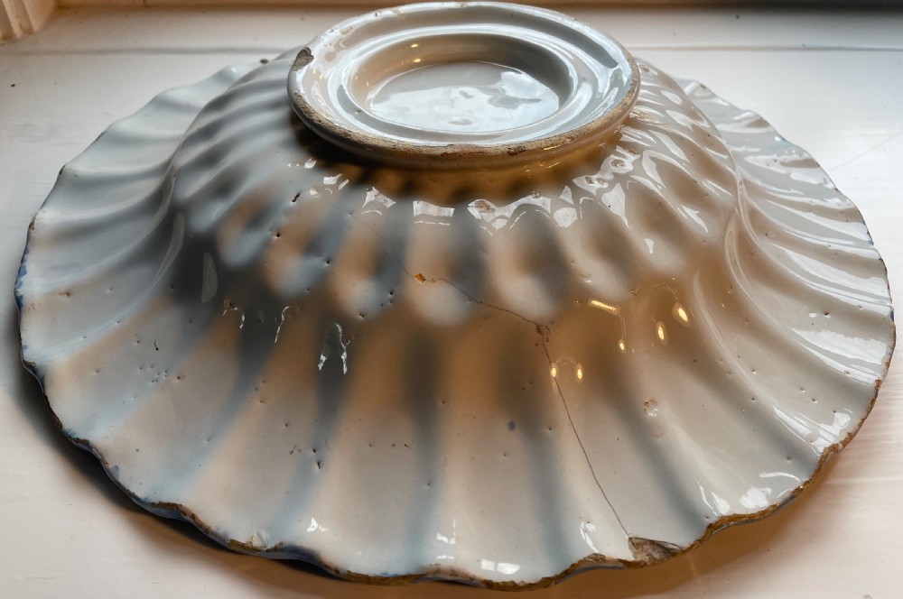 An eighteenth-century Dutch Delftware tin-glazed earthenware shallow bowl with cobalt blue hand-painted Chinoiserie decoration and a fluted edge. View III