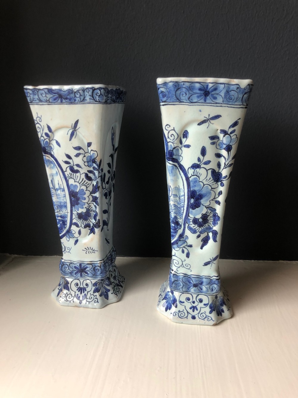 A pair of early nineteenth-century French faience posy vases featuring hand-painted blue maritime vignettes and floral scrollwork on a white background. View II