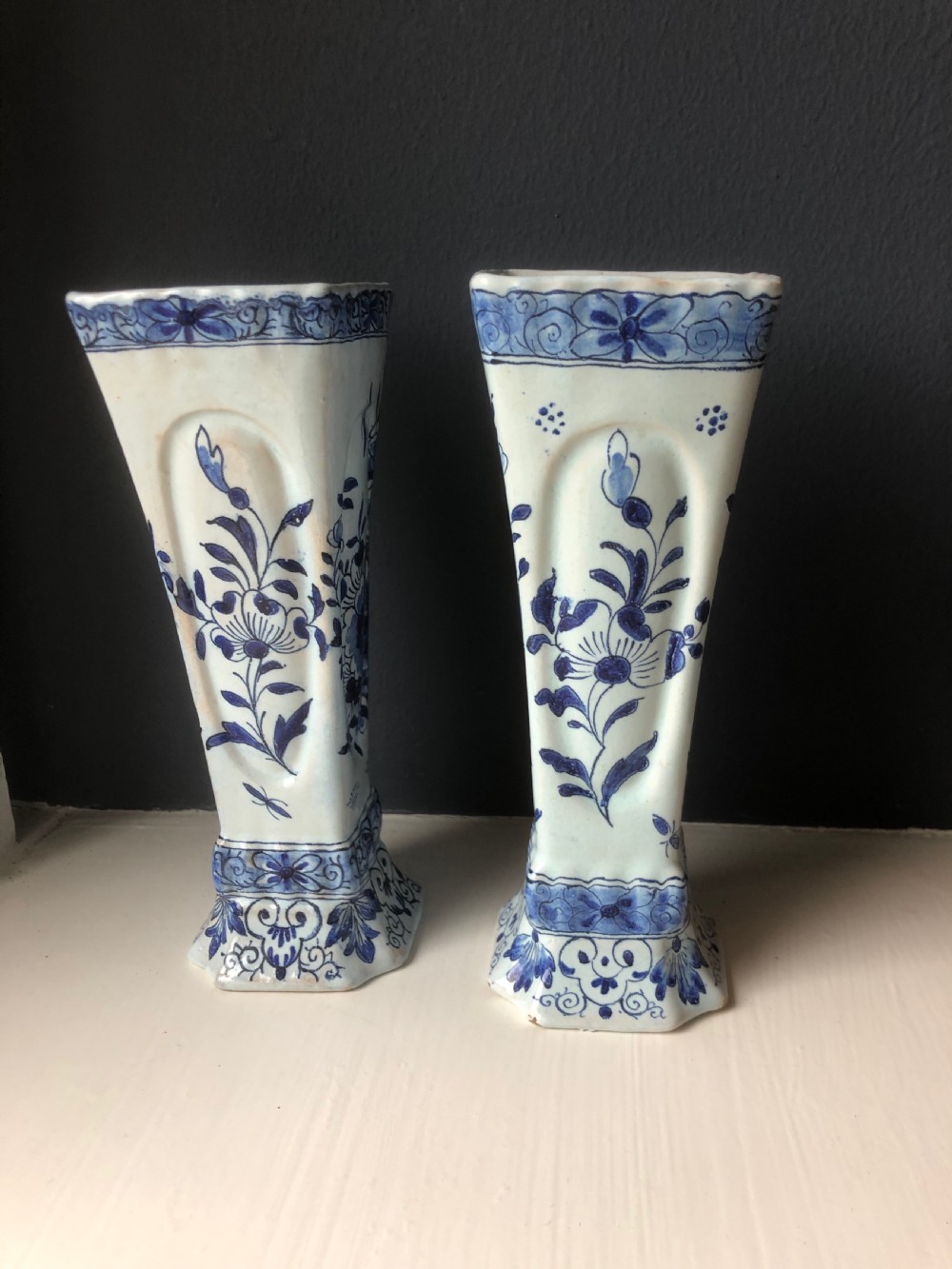 A pair of early nineteenth-century French faience posy vases featuring hand-painted blue maritime vignettes and floral scrollwork on a white background. View III