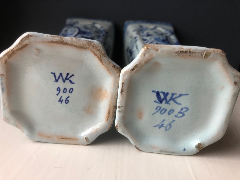A pair of early nineteenth-century French faience posy vases featuring hand-painted blue maritime vignettes and floral scrollwork on a white background. View IV