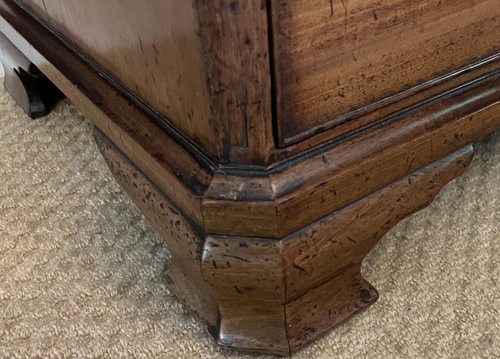 A small 19th-century wooden chest of drawers featuring four graduated drawers with pierced brass handles and bracket feet. View IV