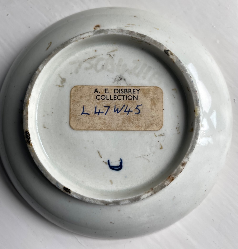 An 18th-century Lowestoft soft-paste porcelain tea bowl and saucer set decorated in underglaze cobalt blue with wavy bands and floral sprays. View XI