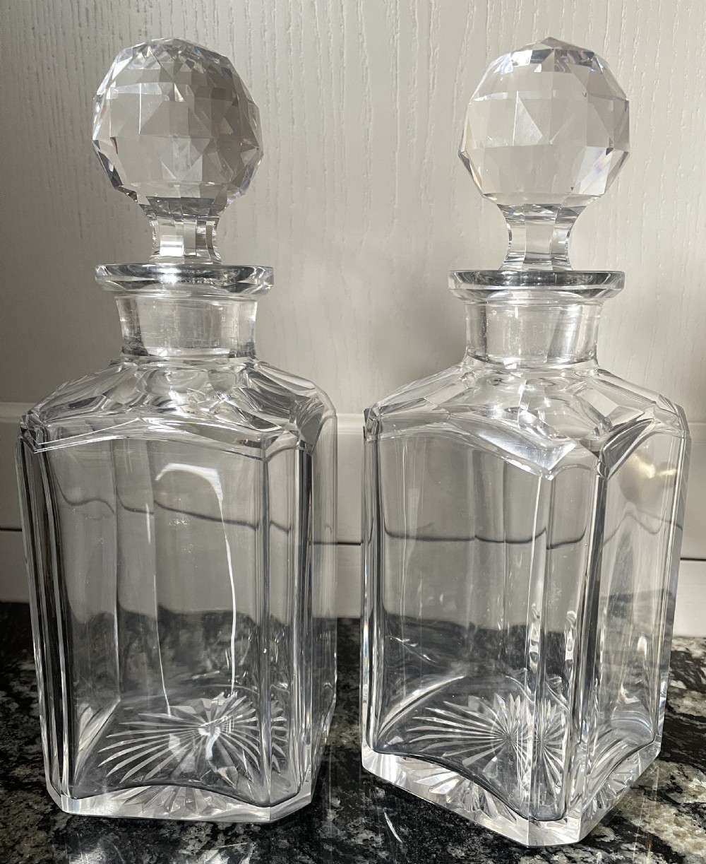 A closed rectangular burr walnut decanter box featuring thin brass trim around the outer edges and a circular brass keyhole escutcheon. View VII