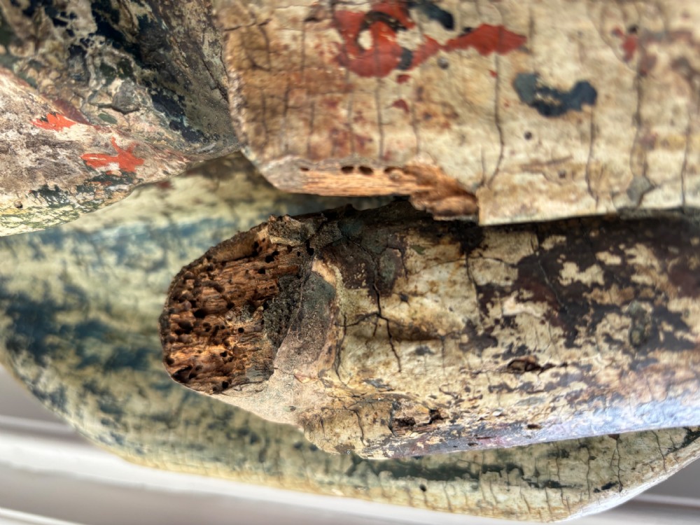 A 17th-century carved wooden figure of Christ with visible remnants of painted polychrome finish, draped robe, and detailed bearded facial features. View VI