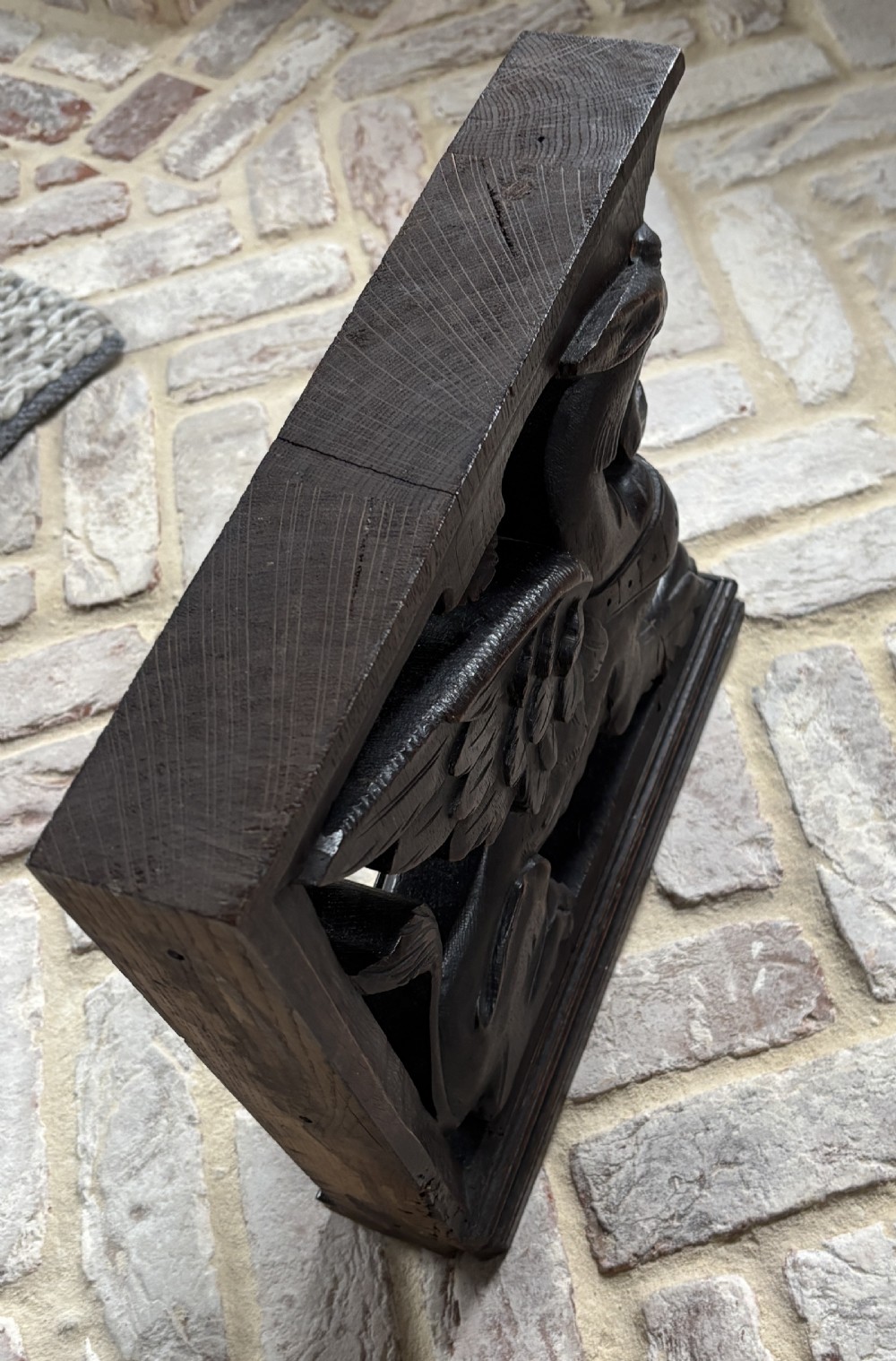 A facing pair of 19th-century carved dark oak panels depicting winged griffins set within rectangular timber frames. View IV