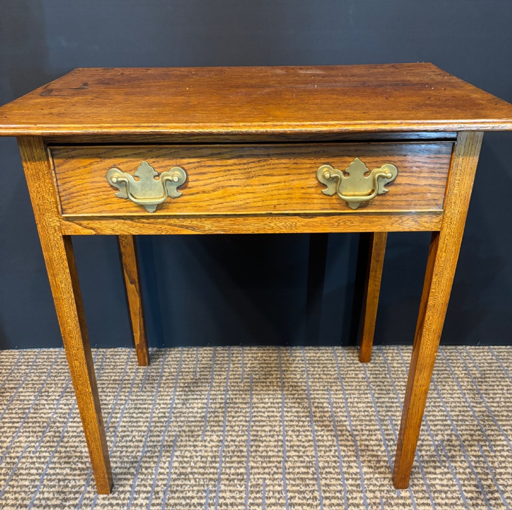 A 19th-century elm side table with a single drawer featuring two brass drop handles and square legs. View IV