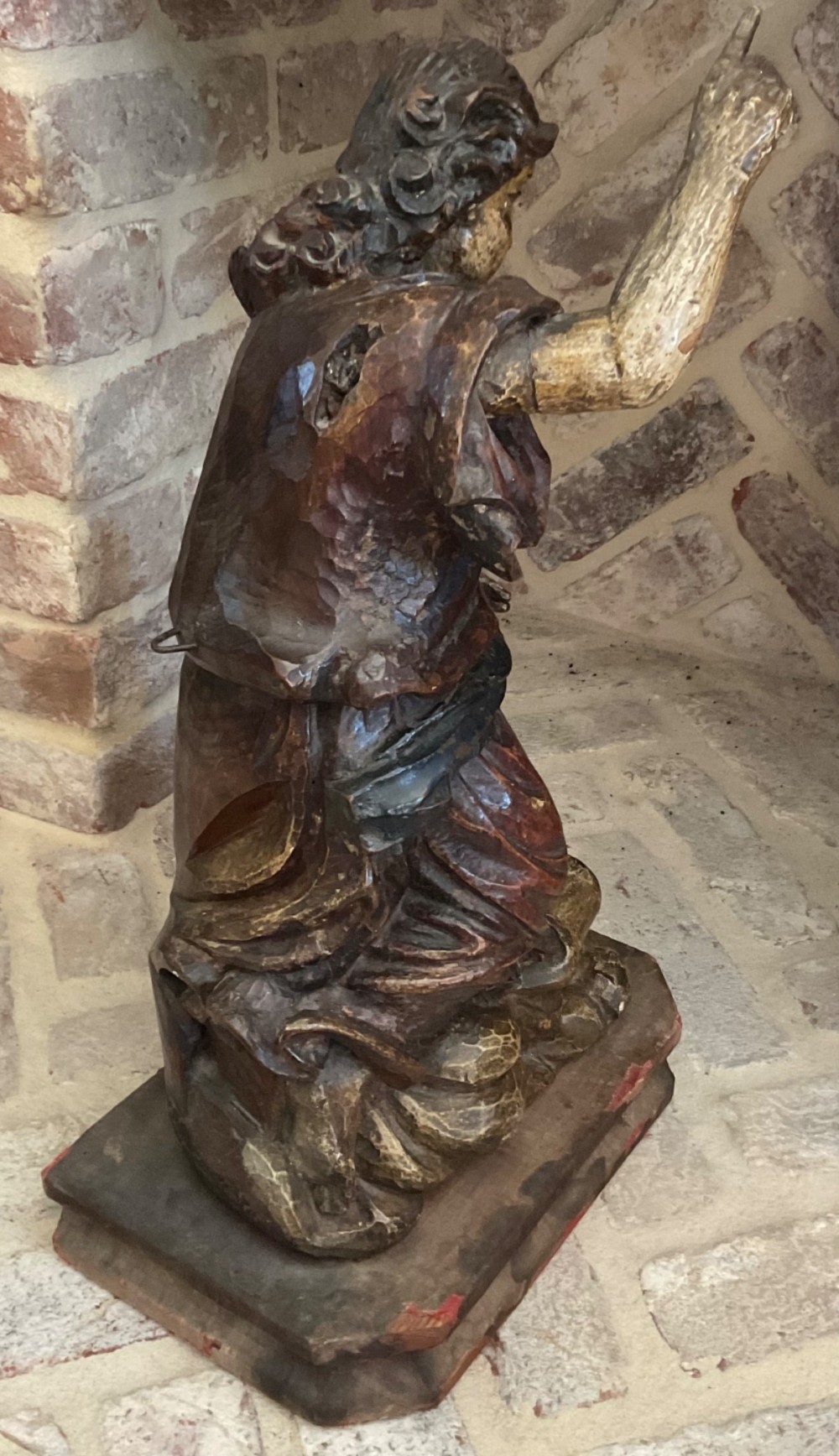 A 17th-century Italian carved polychrome wooden figure of Saint John the Baptist with raised finger and draped robes set upon a carved plinth. View IV