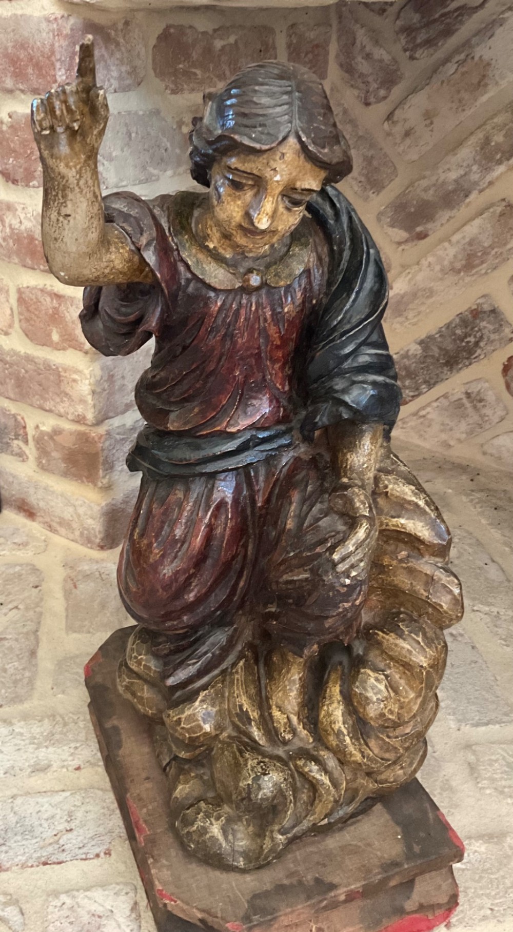 A 17th-century Italian carved polychrome wooden figure of Saint John the Baptist with raised finger and draped robes set upon a carved plinth. View VI