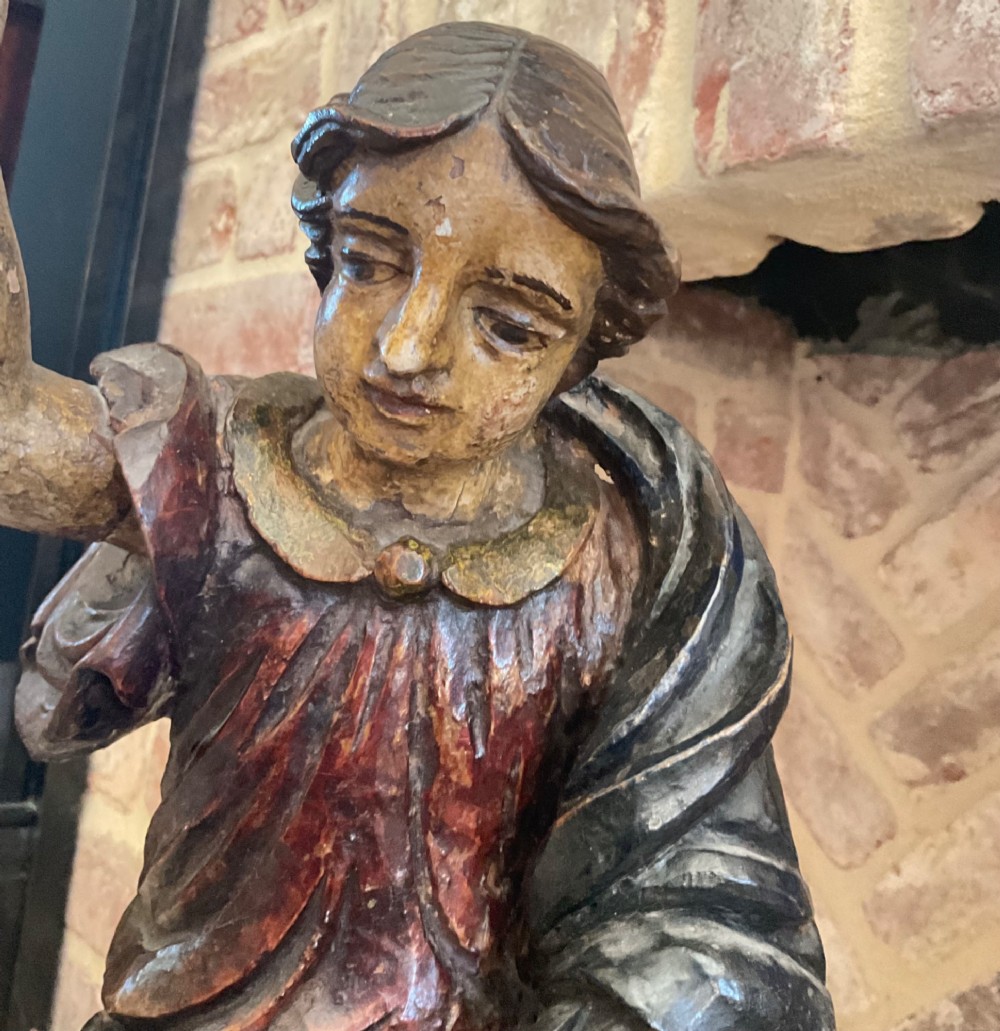A 17th-century Italian carved polychrome wooden figure of Saint John the Baptist with raised finger and draped robes set upon a carved plinth. View VII