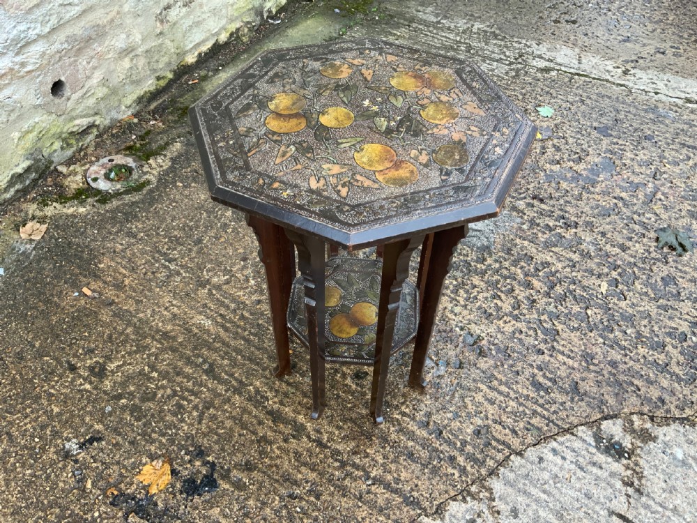 An octagonal dark wood Arts and Crafts occasional table featuring hand-painted fruit motifs on the top surface and lower tier. View IV