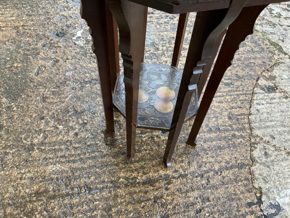 An octagonal dark wood Arts and Crafts occasional table featuring hand-painted fruit motifs on the top surface and lower tier. View VII