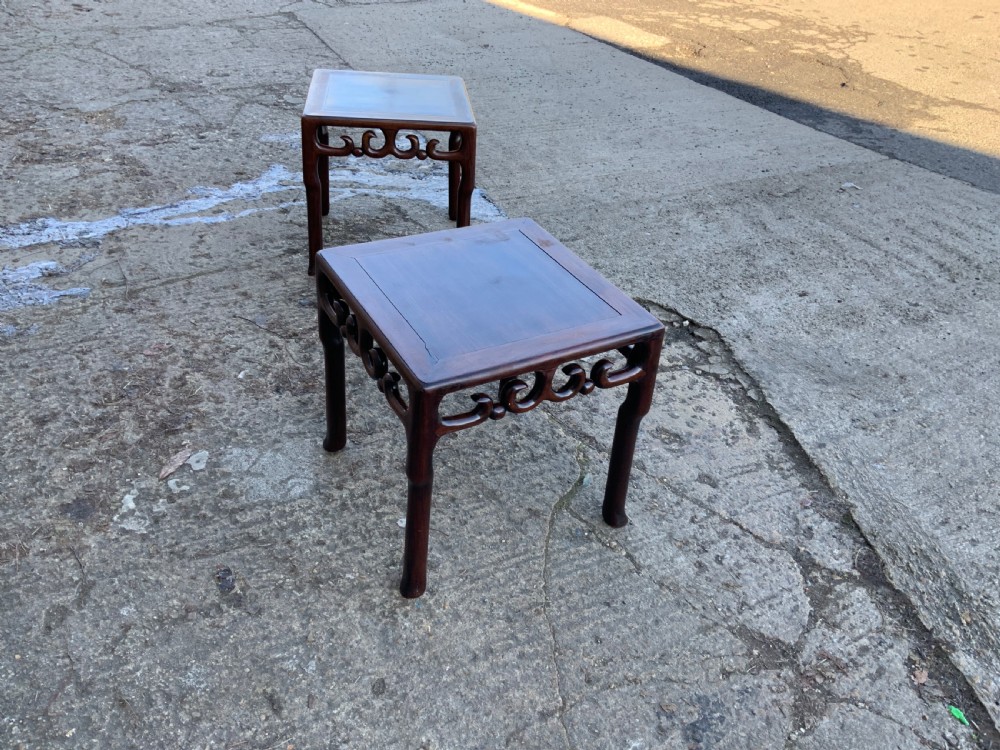 A pair of low square dark brown hardwood side tables featuring carved openwork scroll aprons and shaped legs. View II