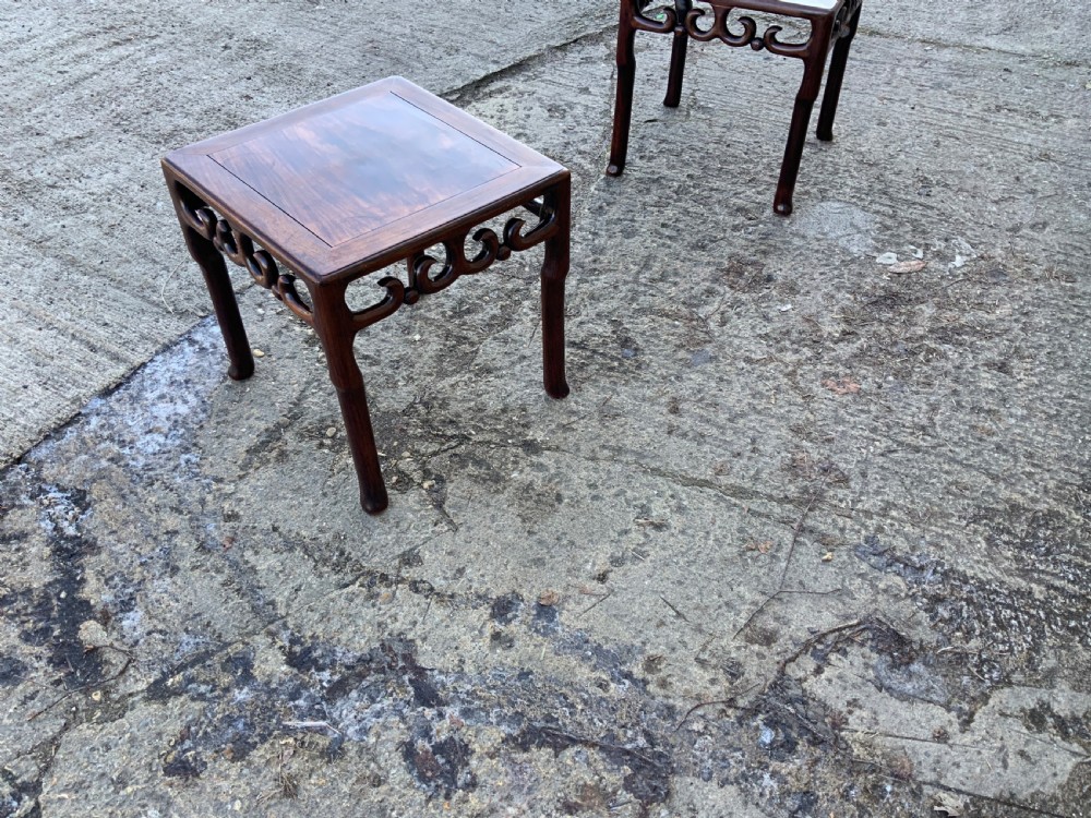 A pair of low square dark brown hardwood side tables featuring carved openwork scroll aprons and shaped legs. View IV