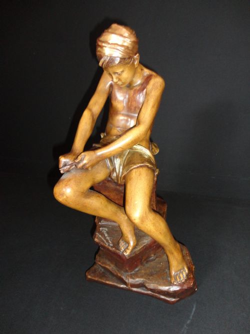 Austrian Terracotta Goldscheider Sculpture of a Boy Whittling a Stick.