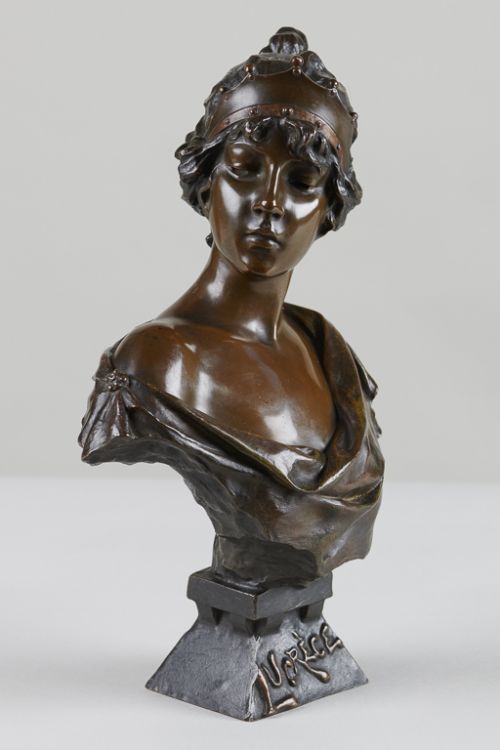 fig 1. An Art Nouveau patinated bronze bust of a woman titled Lucrece, featuring draped fabric, an ornamental headband, and an incised base.