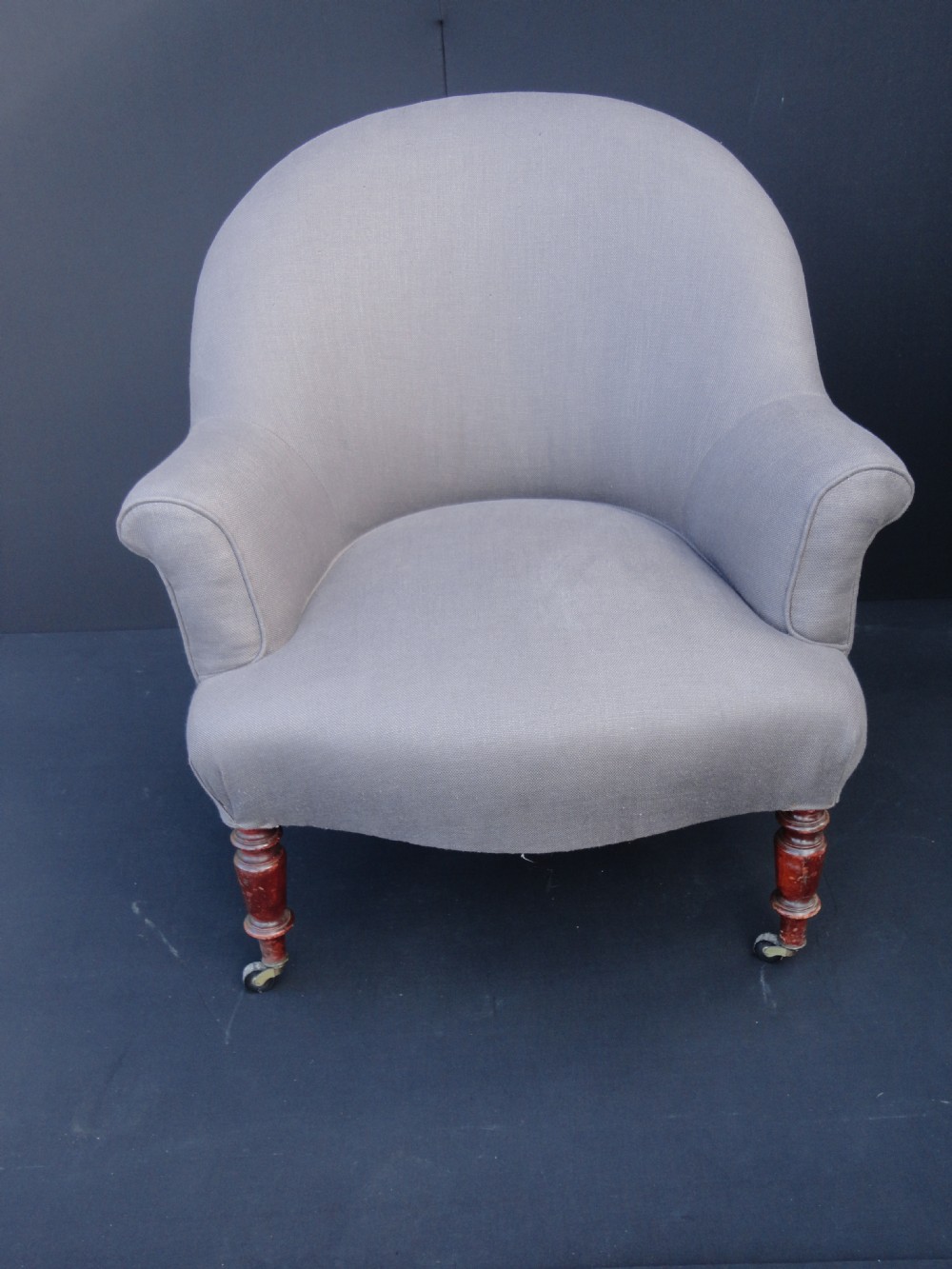French Upholstered Occasional Chair On Turned Legs With Original Casters. 