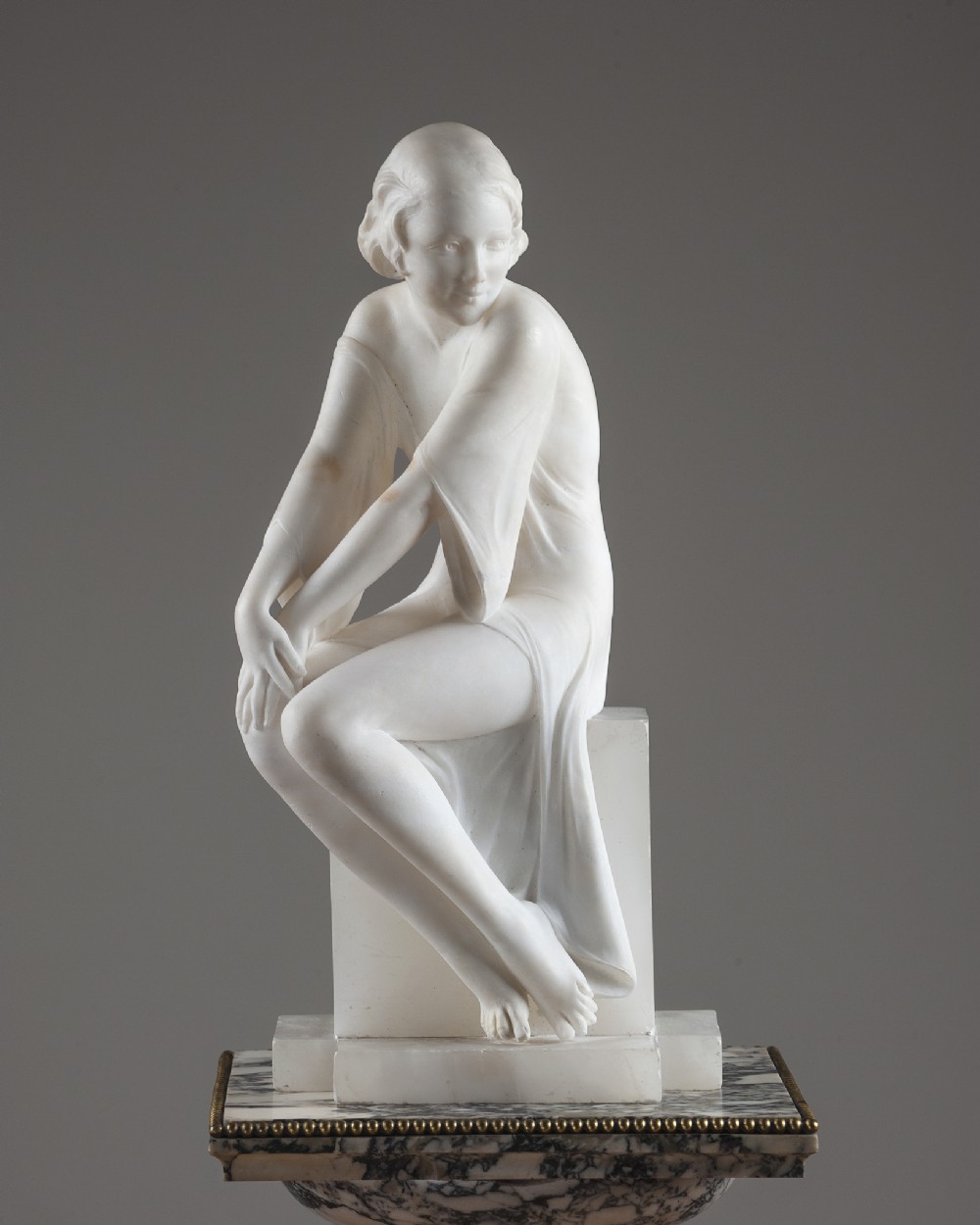 French Art Deco carved alabaster seated sculpture