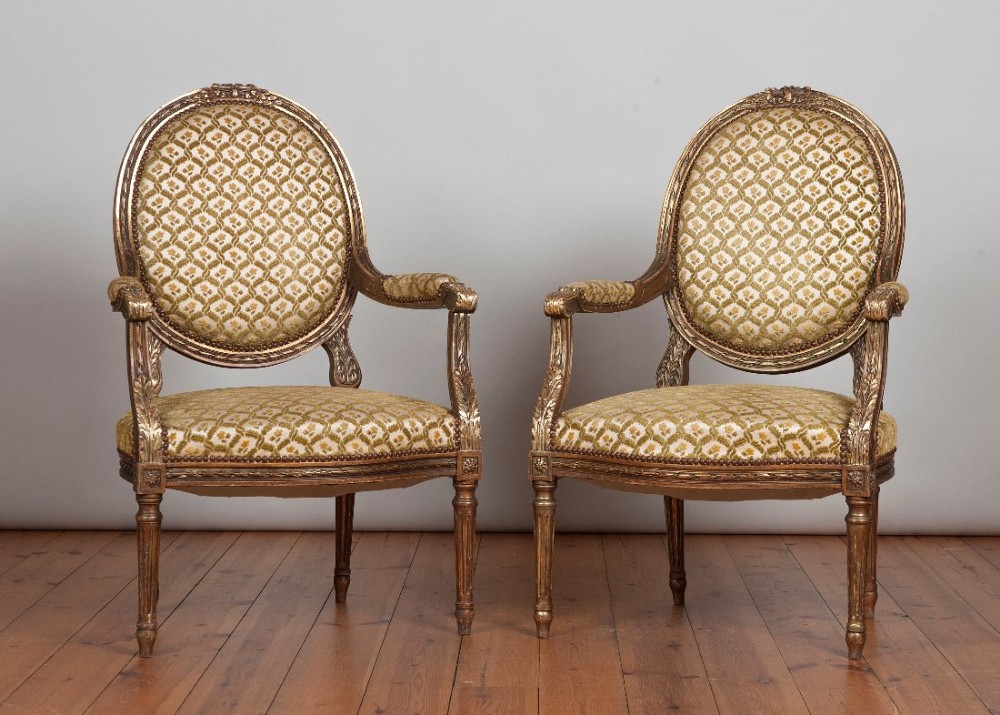 Pair of French Louis XV1 carved wood and gilt upholstered armchairs