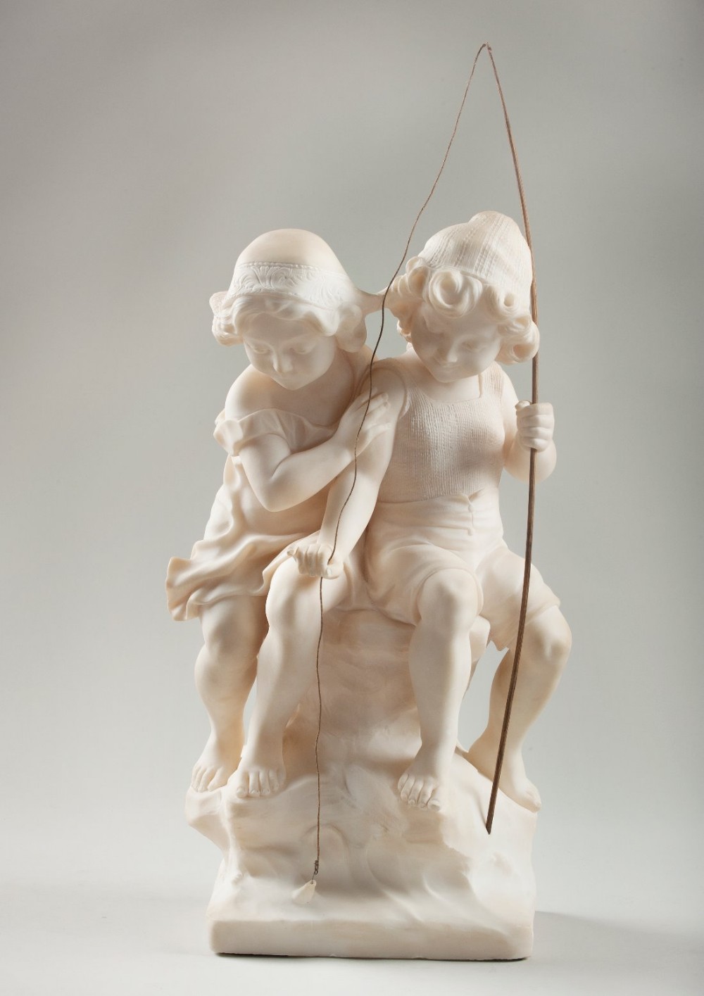French carved alabaster sculpture of children fishing, signed Aug Moreau