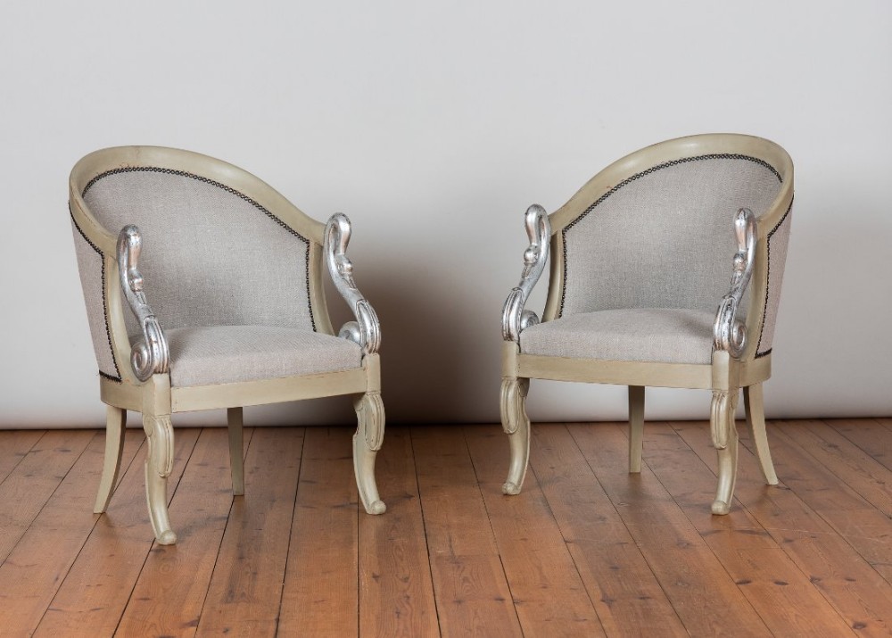 Pair of French painted and parcel silvered Empire style Gondola armchairs