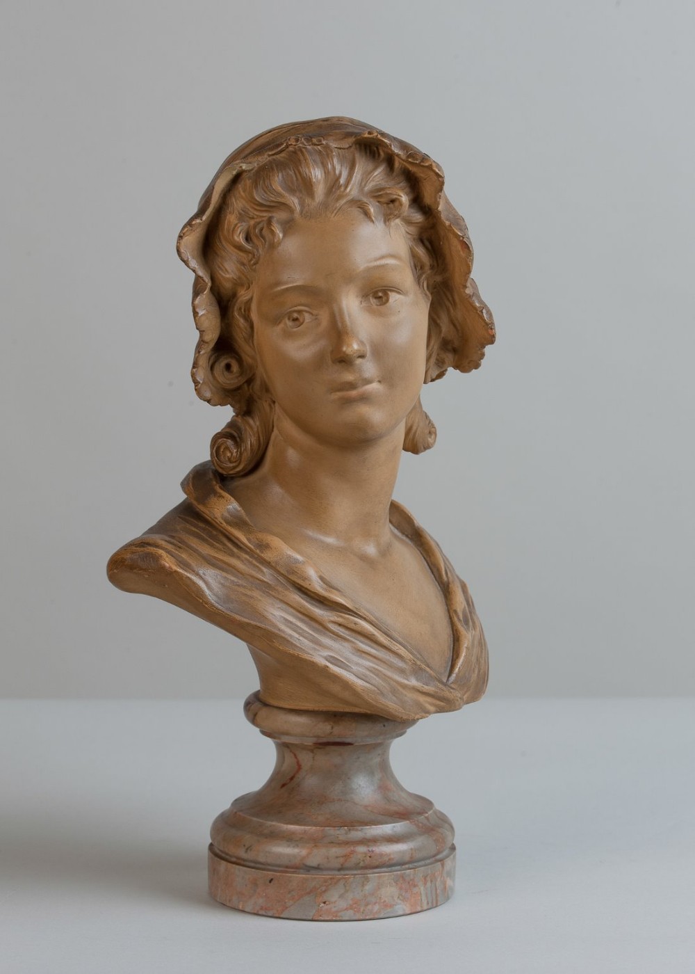 French terracotta sculpture of a female set on a marble base