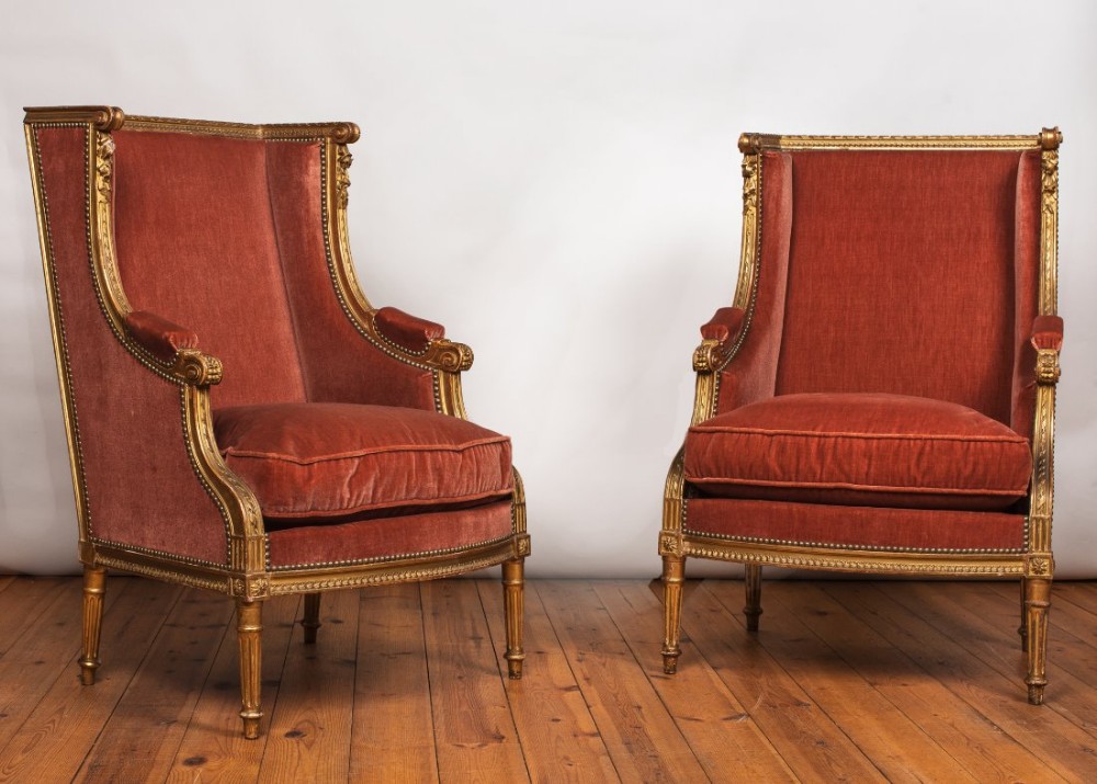 Pair of 19th century French gilded Louis XV1style upholstered bergeres.