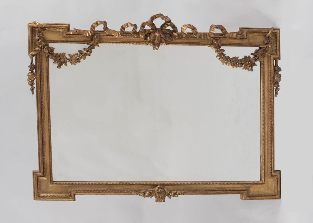 Late 19th century English gilt overmantle mirror with garlands of flowers and ribbon top.