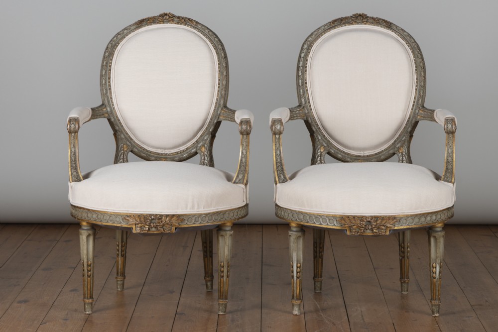 Pair Of Large French Louis XV1 Style Painted And Gilt Upholstered Cabriolet Armchairs.