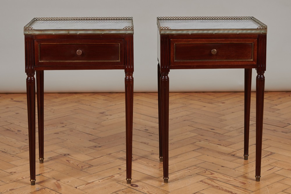 A Pair Of French Mahogany Bedside Tables With Marble Tops.