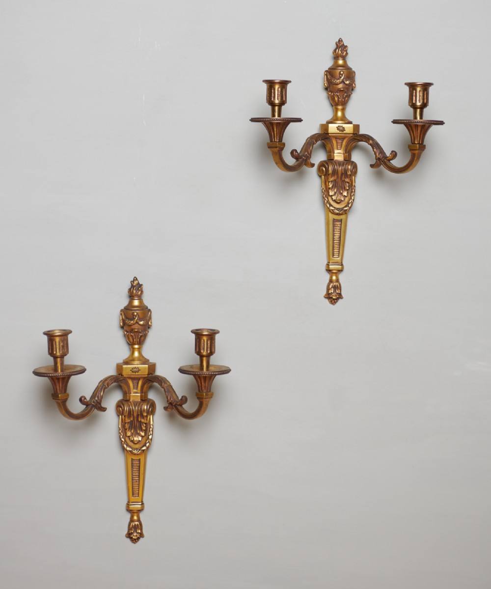 A Pair Of French Twin Arm Brass Torch Top Wall Sconces