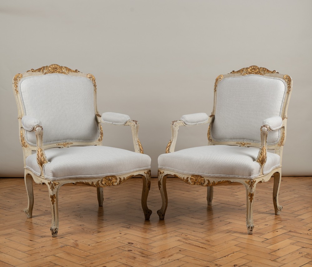 A Pair Of Large French Louis XV Style Painted And Gilt Upholstered Armchairs