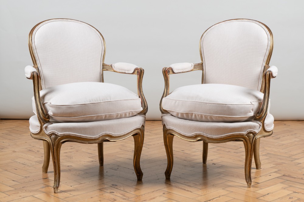 Pair Of French Louis XV Style Painted And Gilt Upholstered Armchairs.