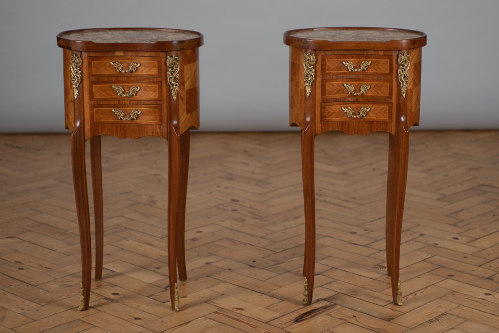 A Pair Of French Three Drawer Kidney Shaped Walnut Bedside Cabinets.