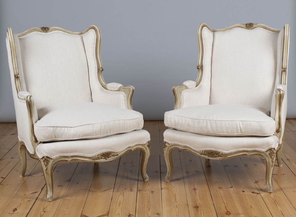 A Pair Of Large French Gilt And Painted Upholstered Bergere Armchairs.