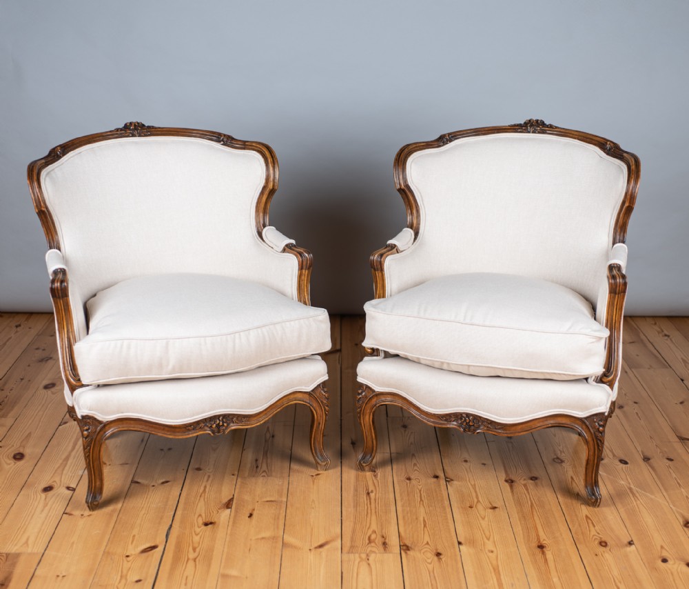 A pair of large Louis XV style Walnut Bergere armchairs