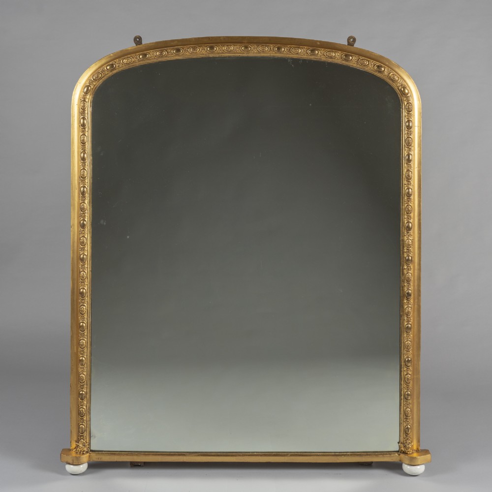 Large 19th Century Victorian English Gilt Archtop Overmantle mirror with porcelain feet