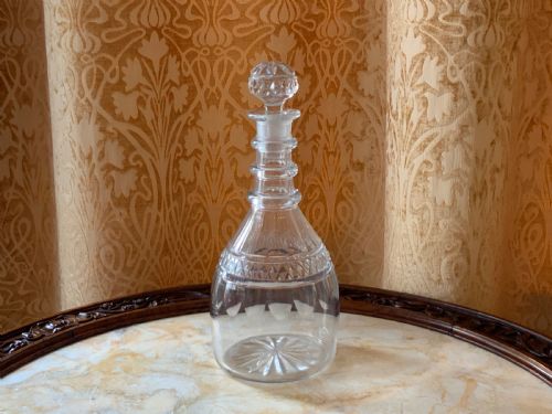 fig 1. A clear Georgian cut glass decanter featuring three neck rings, a diamond cut band, and a matching mushroom-shaped faceted stopper.