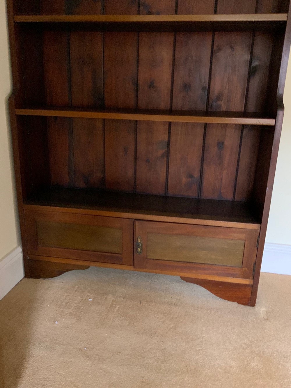 A tall antique dark mahogany open bookcase featuring multiple exposed shelves above a two-door base cupboard. View VIII