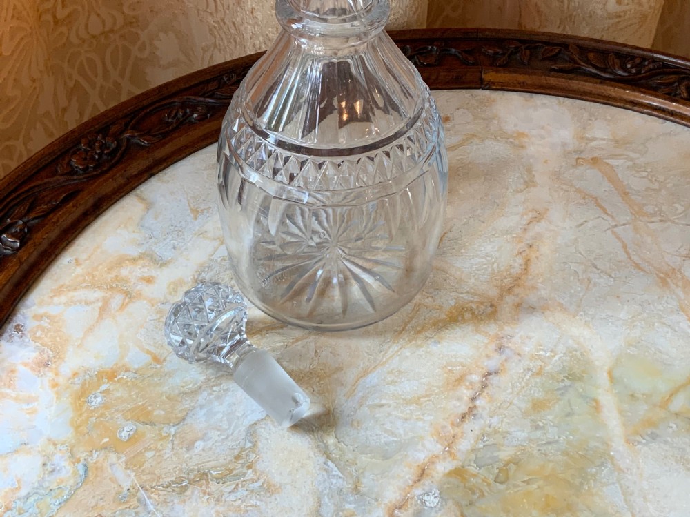 A clear Georgian cut glass decanter featuring three neck rings, a diamond cut band, and a matching mushroom-shaped faceted stopper. View III