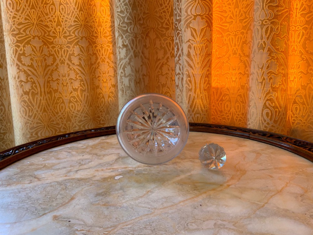 A clear Georgian cut glass decanter featuring three neck rings, a diamond cut band, and a matching mushroom-shaped faceted stopper. View IV